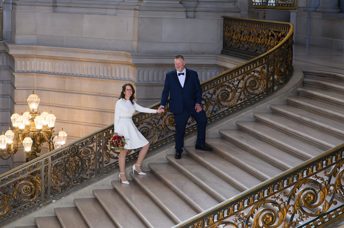 SF city hall wedding on the Grand Staircase holding hands