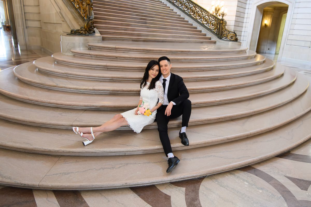 Flowers at San Francisco city hall with bride and groom posing