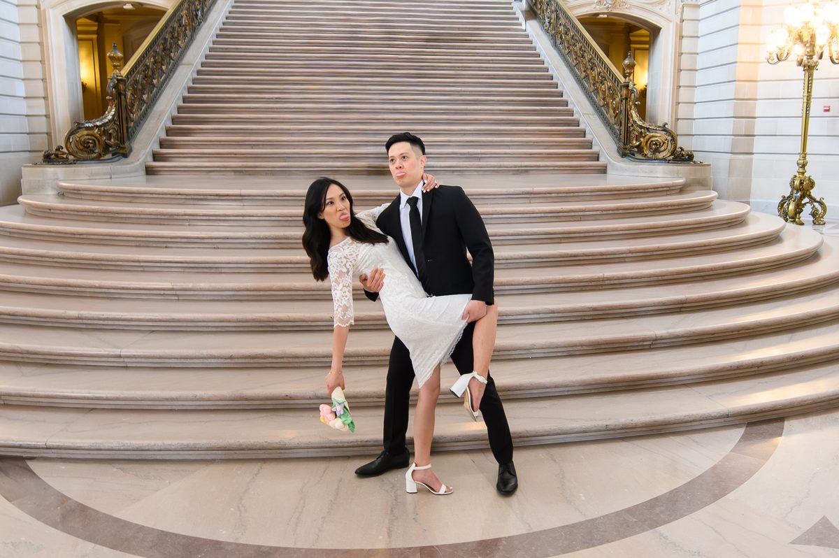 Bride and groom making funny faces at SF City Hall
